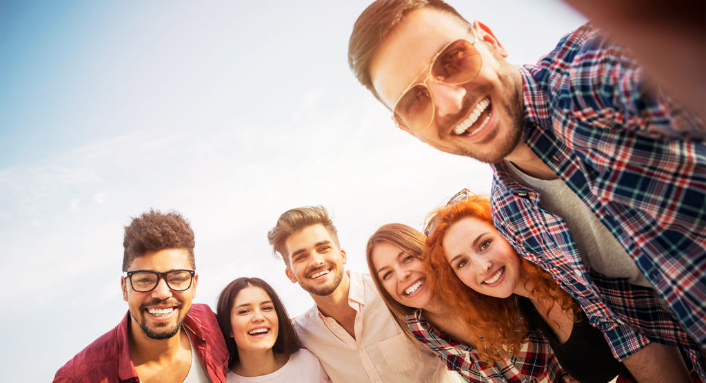 Zana Website Homepage header with happy young adults smiling with each other